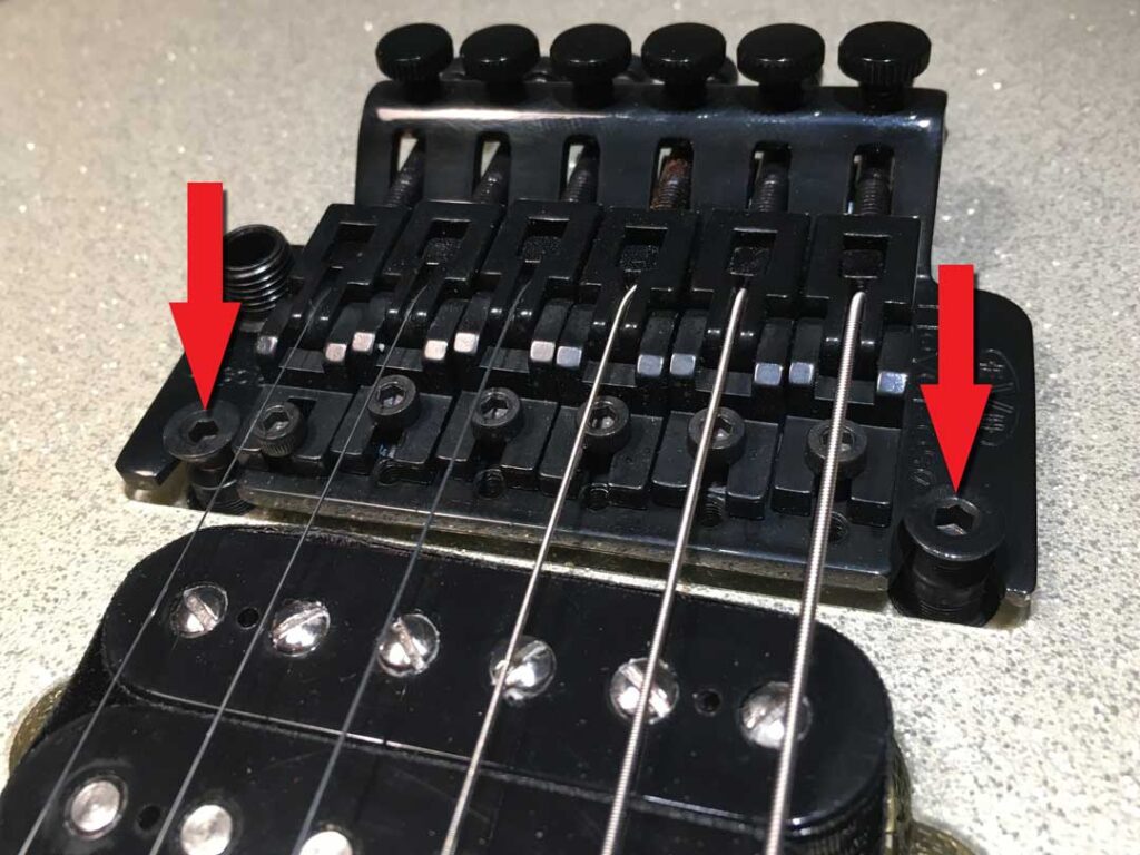 Locking tremolo bridge height adjustment points