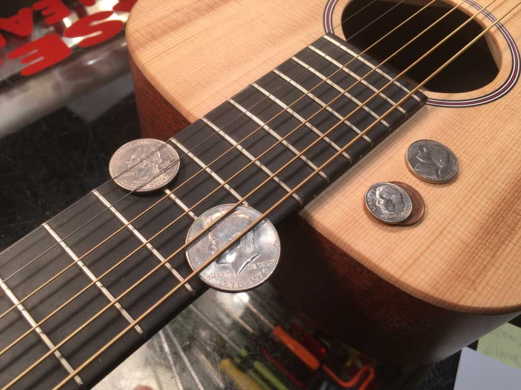 Using coins to check string height on a Martin LX1 acoustic